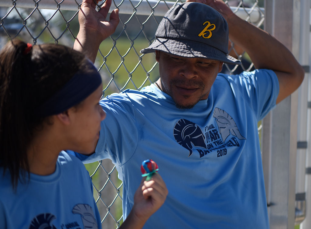 Corn Roland, right, talks to his daughter Jacei Roland, 12